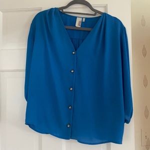 Feminine blue top with pearl button accents